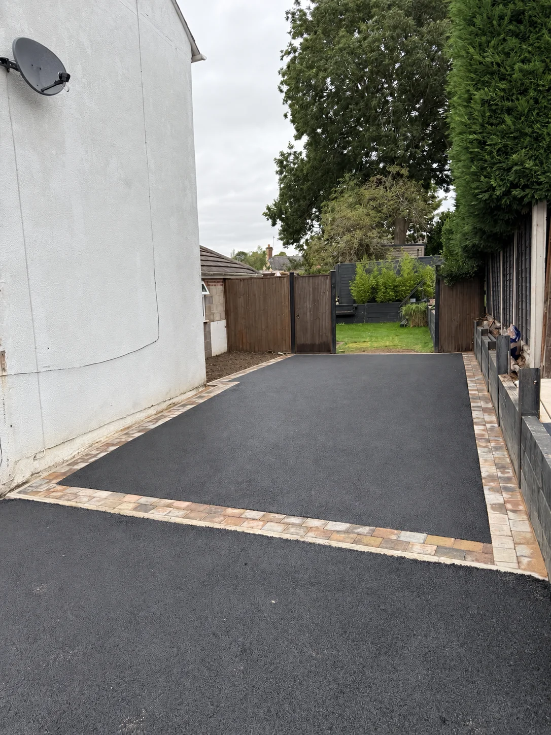 Tarmac Driveway Transformation in Stourbridge Finished Stourbridge tarmac driveway showing the Marshalls Drivesett Tegula block paving border and cross border